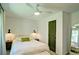 Inviting bedroom featuring a queen bed with a white duvet, a ceiling fan, and neutral decor at 101 Stroud Se Dr, Mableton, GA 30126