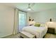 Inviting bedroom featuring a queen bed with a white duvet, a ceiling fan, and neutral decor at 101 Stroud Se Dr, Mableton, GA 30126