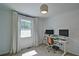 Bright bedroom with a dedicated office area and a window overlooking the landscape at 101 Stroud Se Dr, Mableton, GA 30126