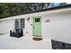 Charming front entrance featuring a light green door, a black bench, and modern house number at 101 Stroud Se Dr, Mableton, GA 30126