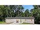 Charming white brick house with a green door and a well-manicured lawn surrounded by lush trees at 101 Stroud Se Dr, Mableton, GA 30126