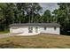 Charming white brick home with a green front door and a well-manicured lawn at 101 Stroud Se Dr, Mableton, GA 30126