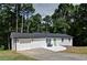 Charming white brick home with a green front door and a well-manicured lawn at 101 Stroud Se Dr, Mableton, GA 30126