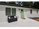Inviting front porch with a comfortable bench, a light green door, and elegant black hardware at 101 Stroud Se Dr, Mableton, GA 30126