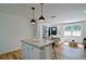 Open floorplan with kitchen island flowing to a living area featuring lots of natural light from large windows at 101 Stroud Se Dr, Mableton, GA 30126