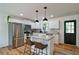 Bright kitchen featuring white cabinets, stainless appliances, granite countertops, and island with stool seating at 101 Stroud Se Dr, Mableton, GA 30126