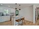 Bright kitchen with white cabinets, granite counters, stainless steel dishwasher and island with stool seating at 101 Stroud Se Dr, Mableton, GA 30126