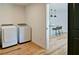 Laundry room equipped with modern front-load washer and dryer, conveniently located near the kitchen at 101 Stroud Se Dr, Mableton, GA 30126