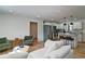 Open-concept living room with a modern kitchen, stainless steel appliances, and stylish island seating at 101 Stroud Se Dr, Mableton, GA 30126