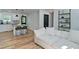 Spacious living room adjacent to a modern kitchen, featuring a plush white sofa and sleek bar stools at 101 Stroud Se Dr, Mableton, GA 30126