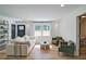 Bright living room with white sofa, green chairs, stylish decor, and large window view at 101 Stroud Se Dr, Mableton, GA 30126