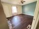 Bedroom with hardwood floors, a ceiling fan, a window, and a door at 142 Davis Mill Ct, Lawrenceville, GA 30044