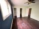 Spacious bedroom with hardwood floors, ceiling fan, large window and access to bathroom and closet at 142 Davis Mill Ct, Lawrenceville, GA 30044