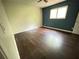 Bedroom with hardwood floors, a ceiling fan, and plenty of natural light from the large window at 142 Davis Mill Ct, Lawrenceville, GA 30044