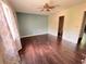 Bedroom featuring a ceiling fan, hardwood floors, a window, and access to the bathroom at 142 Davis Mill Ct, Lawrenceville, GA 30044