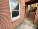 Close-up view of the brick entrance with a window and red door, showcasing a private entry at 142 Davis Mill Ct, Lawrenceville, GA 30044
