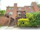 Brick condo building featuring multiple stories, a well-maintained entrance, and lush surrounding greenery at 142 Davis Mill Ct, Lawrenceville, GA 30044