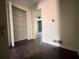 Hallway featuring hardwood floors, and access to a large shelved closet and another room at 142 Davis Mill Ct, Lawrenceville, GA 30044