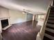 Open-concept living space with hardwood floors, a fireplace, and a partial view of the kitchen at 142 Davis Mill Ct, Lawrenceville, GA 30044