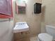 Bathroom showcasing a toilet, mirror, sink and hexagon tile flooring at 1517 Colony East Cir, Stone Mountain, GA 30083