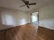 Spacious bedroom with hardwood floors, ceiling fan, and a view into an adjacent room at 1517 Colony East Cir, Stone Mountain, GA 30083
