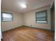 Empty bedroom featuring hardwood floors, and two windows providing natural light at 1517 Colony East Cir, Stone Mountain, GA 30083