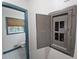 View of the electrical panel with its door partially open, and a partial bathroom view through a doorway at 1517 Colony East Cir, Stone Mountain, GA 30083