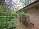Side view of the brick home exterior with surrounding greenery at 1517 Colony East Cir, Stone Mountain, GA 30083