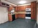 Cozy kitchen featuring wood cabinets, white appliances, and a practical layout at 1517 Colony East Cir, Stone Mountain, GA 30083