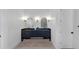Elegant bathroom featuring a dual vanity with dark cabinetry and arched mirrors at 2577 Kilgore Rd, Buford, GA 30519