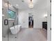 Luxurious bathroom featuring a soaking tub, frameless shower, and walk-in closet at 2577 Kilgore Rd, Buford, GA 30519