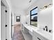 Elegant bathroom showcasing double sinks, modern fixtures, and a view to the backyard at 2577 Kilgore Rd, Buford, GA 30519