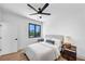 Bright bedroom featuring hardwood floors, a ceiling fan, and a serene window view at 2577 Kilgore Rd, Buford, GA 30519