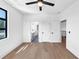 Bright bedroom with hardwood floors, a ceiling fan, and an attached bathroom at 2577 Kilgore Rd, Buford, GA 30519