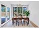 Bright dining room with modern chandelier, natural light, and view to backyard at 2577 Kilgore Rd, Buford, GA 30519