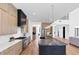 Open-concept kitchen with a large island, stainless steel appliances, and light wood cabinetry at 2577 Kilgore Rd, Buford, GA 30519