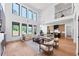 Bright, open-concept living room featuring large windows, light wood floors, and modern lighting at 2577 Kilgore Rd, Buford, GA 30519
