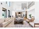 Open-concept living room with soaring ceilings, contemporary furnishings, and seamless flow to the kitchen at 2577 Kilgore Rd, Buford, GA 30519