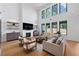 Spacious living room with a modern fireplace, high ceilings, and an abundance of natural light at 2577 Kilgore Rd, Buford, GA 30519