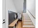 Functional mudroom with a wooden bench, storage, and coat hooks near the staircase at 2577 Kilgore Rd, Buford, GA 30519