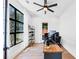 Bright office with hardwood floors, a modern desk, and a large window overlooking the yard at 2577 Kilgore Rd, Buford, GA 30519