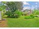 Expansive green backyard features a two-story home with brick accents and lush landscaping at 3240 Corktree Trl, Stonecrest, GA 30038
