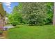 Expansive backyard featuring lush greenery and mature trees, creating a serene outdoor space at 3240 Corktree Trl, Stonecrest, GA 30038