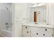 This bathroom features a tub/shower combo, vanity with sink, white cabinets and modern fixtures at 3240 Corktree Trl, Stonecrest, GA 30038