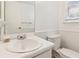 Well-lit bathroom with a white sink, toilet, and ample counter space at 3240 Corktree Trl, Stonecrest, GA 30038