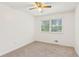 Bright bedroom with neutral carpet, ceiling fan, and natural light from the window at 3240 Corktree Trl, Stonecrest, GA 30038