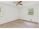 Empty bedroom with carpet, ceiling fan, and window at 3240 Corktree Trl, Stonecrest, GA 30038