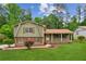 Charming home featuring mature trees, a well-maintained lawn and an inviting exterior at 3240 Corktree Trl, Stonecrest, GA 30038
