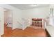 Eat-in kitchen with wood floors and view to lower level living room and brick fireplace at 3240 Corktree Trl, Stonecrest, GA 30038
