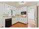 Functional kitchen featuring white cabinets, countertops and modern appliances at 3240 Corktree Trl, Stonecrest, GA 30038